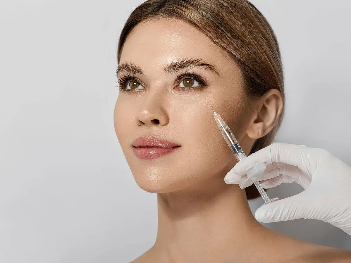 Woman undergoing mesotherapy on her face